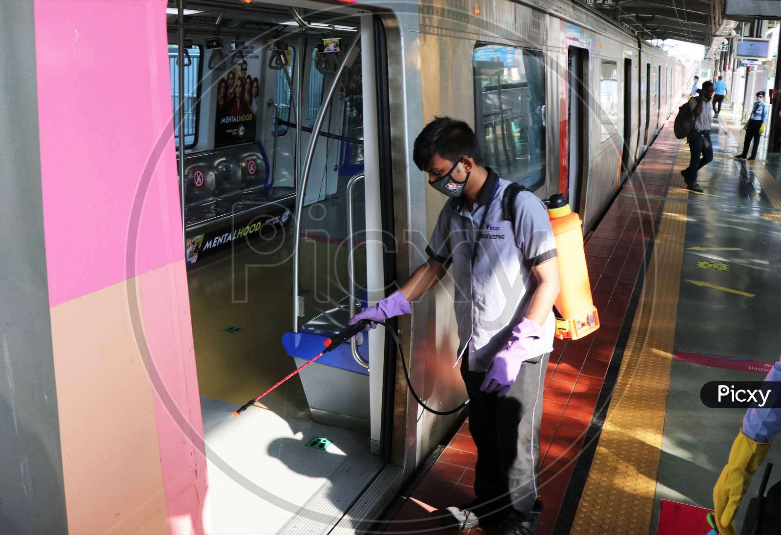 A worker sanitizes a coach as the metro network prepares to resume services after more than a 6-month shutdown due to the Covid-19 coronavirus pandemic, at the Andheri metro station in Mumbai, October, 2020.