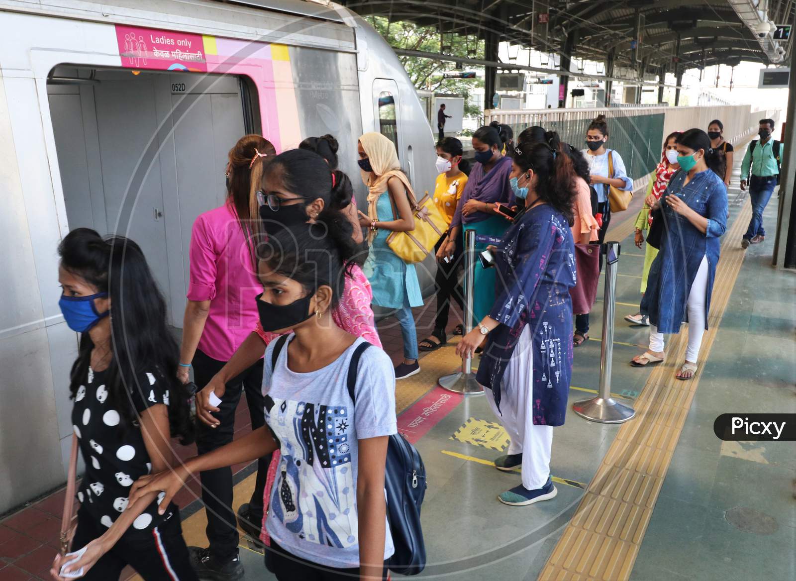 Commuters wearing protective face masks board a metro after authorities resumed the metro services, amidst the coronavirus disease (COVID-19) outbreak, in Mumbai, India, October 28, 2020.