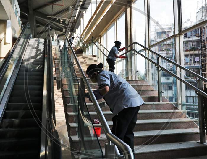 Workers clean a platform as the metro network prepares to resume services after more than a 6-month shutdown due to the Covid-19 coronavirus pandemic, at the Andheri metro station in Mumbai, October, 2020.