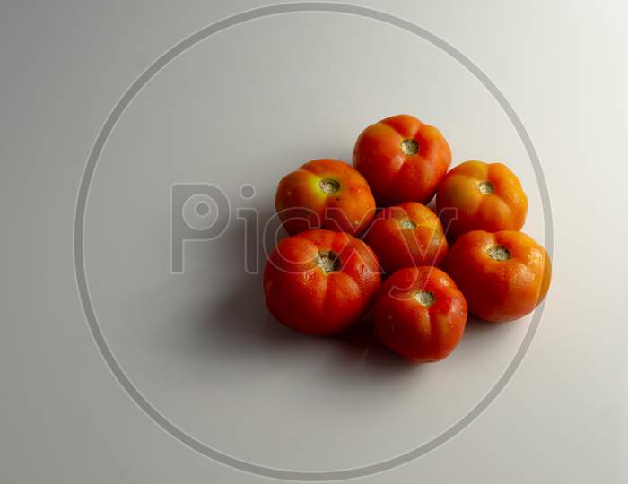 Group Of Red Tomatoes On The Table