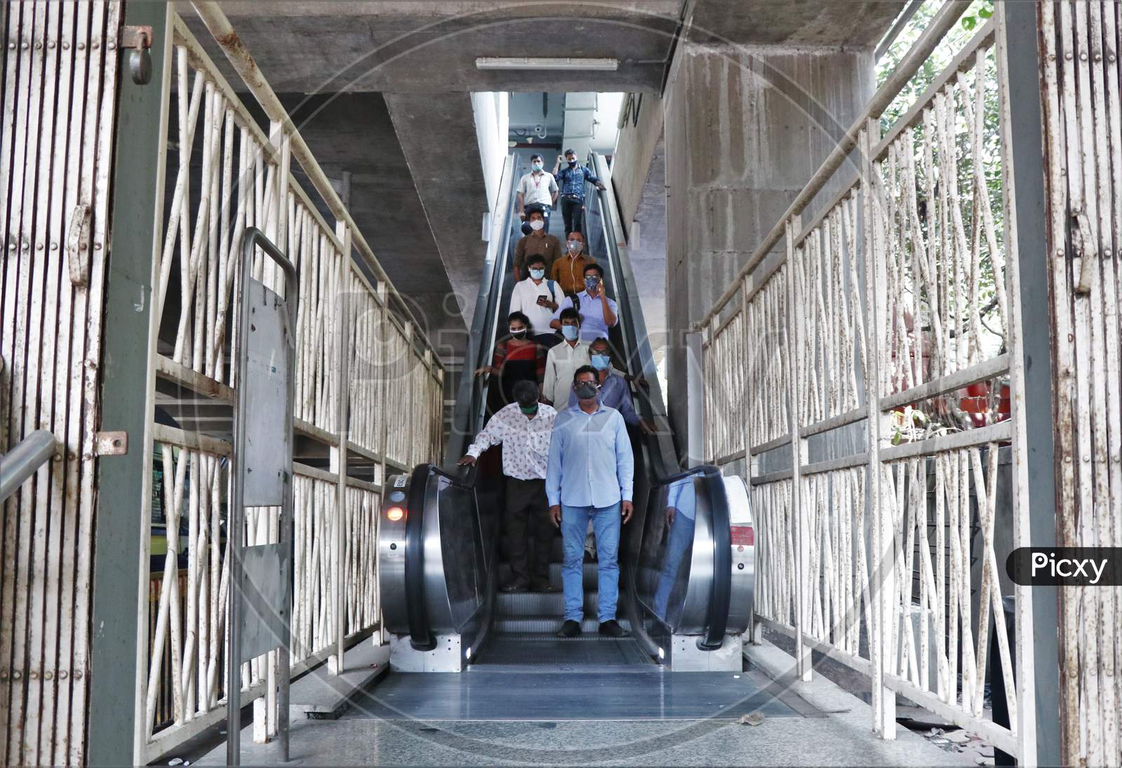 Commuters wearing face masks are seen exiting a station, after metro resumed services, amidst the spread of the coronavirus disease (COVID-19) in Mumbai, India, October 28, 2020.