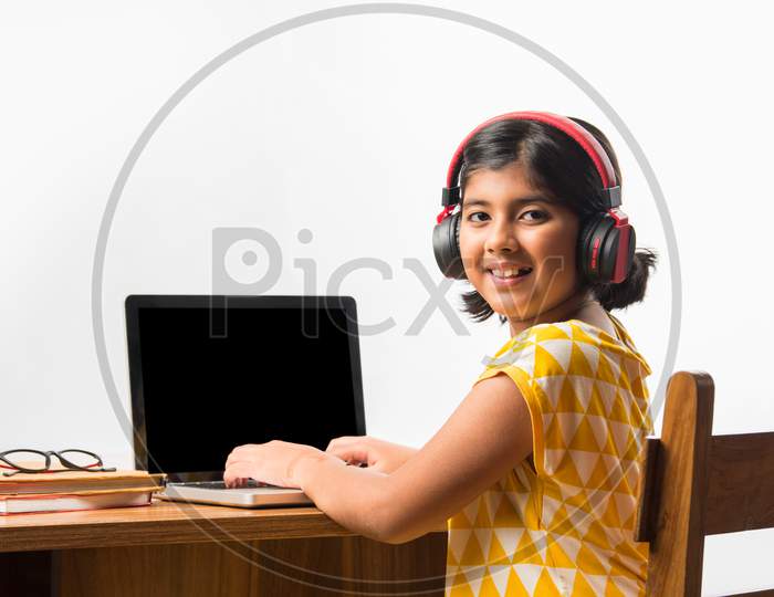 Indian Girl Studying Using Laptop Or Tablet During Home Schooling - Online Learning Concept