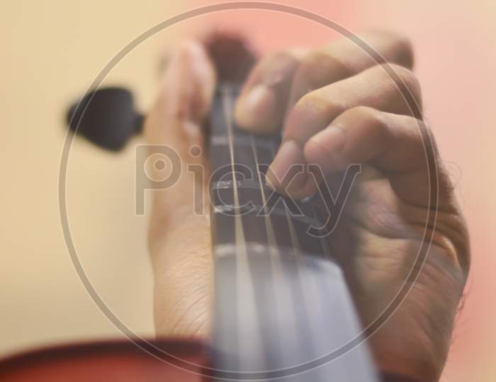 Close Up Image Of Hands Playing A Violin