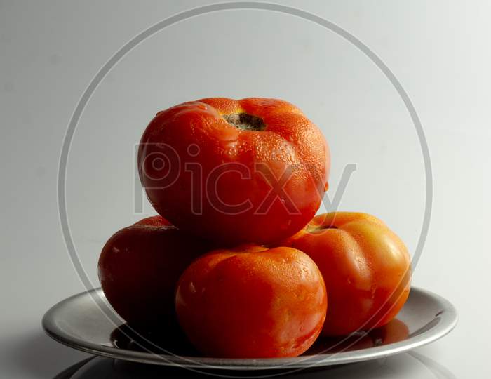 Tomatoes Stacked Together In A Plate