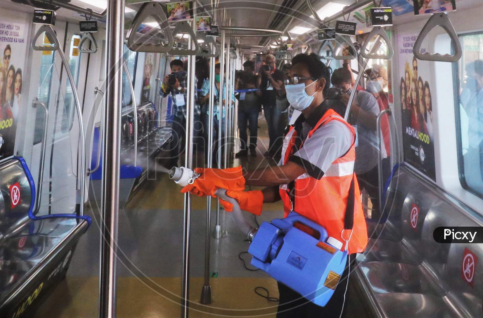 A worker sanitizes a coach as the metro network prepares to resume services after more than a 6-month shutdown due to the Covid-19 coronavirus pandemic, at the Andheri metro station in Mumbai, October, 2020.