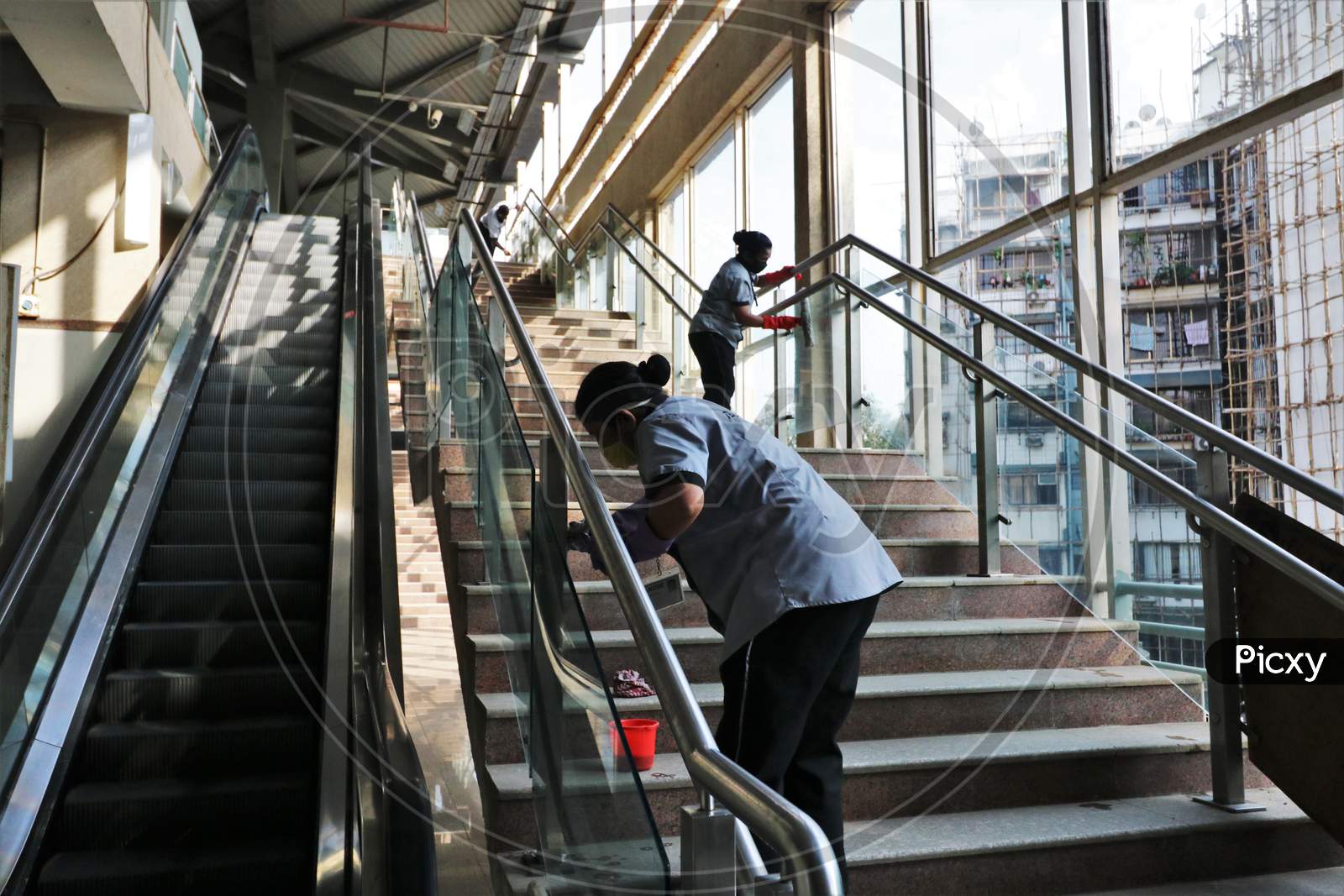 Workers clean a platform as the metro network prepares to resume services after more than a 6-month shutdown due to the Covid-19 coronavirus pandemic, at the Andheri metro station in Mumbai, October, 2020.