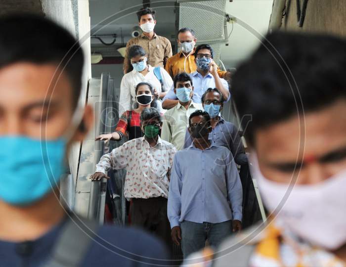 Commuters wearing face masks are seen exiting a station, after metro resumed services, amidst the spread of the coronavirus disease (COVID-19) in Mumbai, India, October 28, 2020.