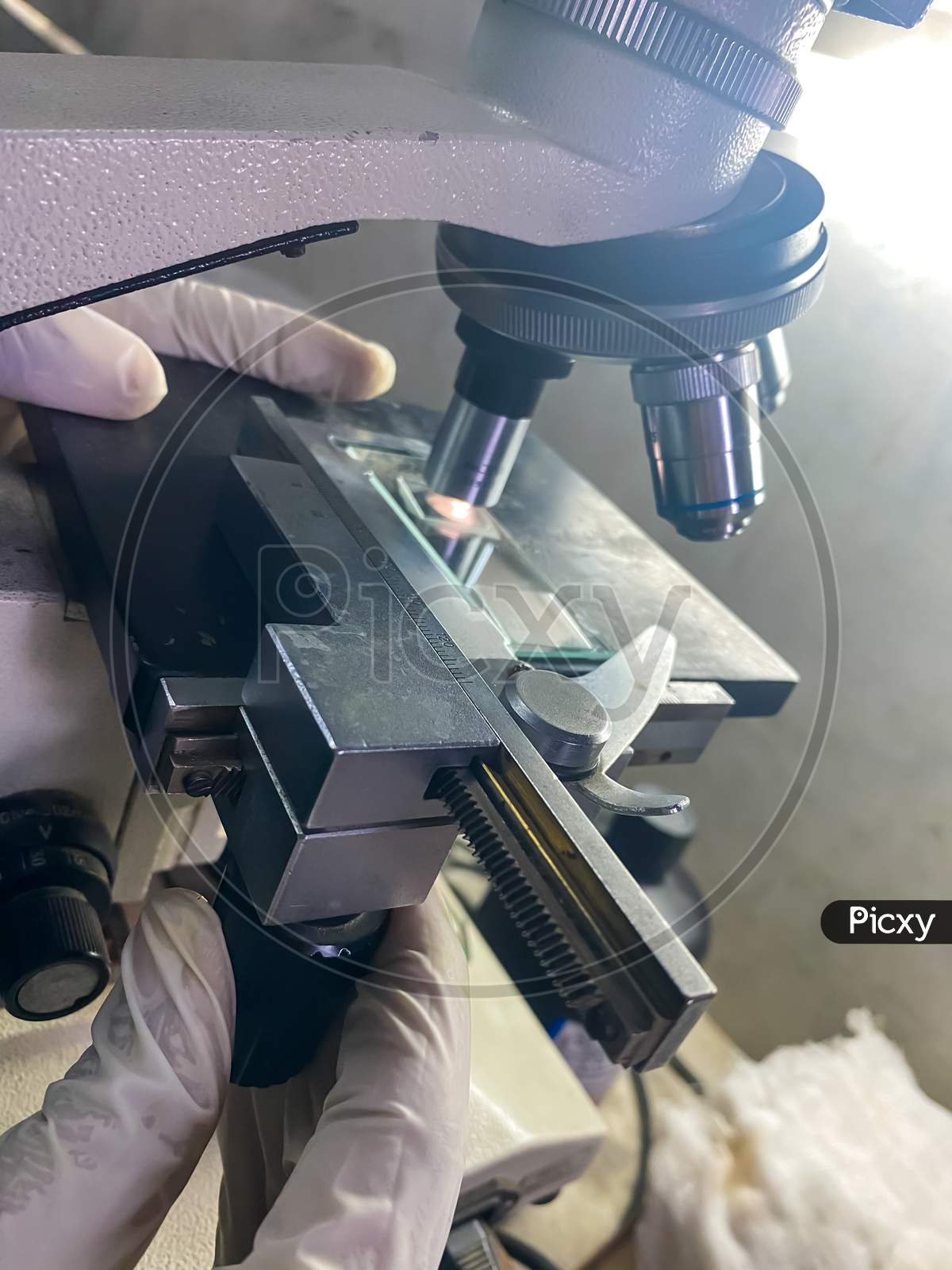 A view of a scientist working on a microscope
