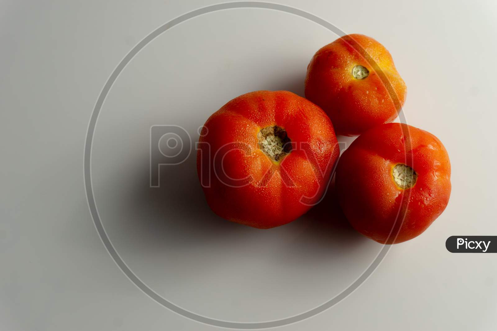 Three Red Tomatoes On The Table