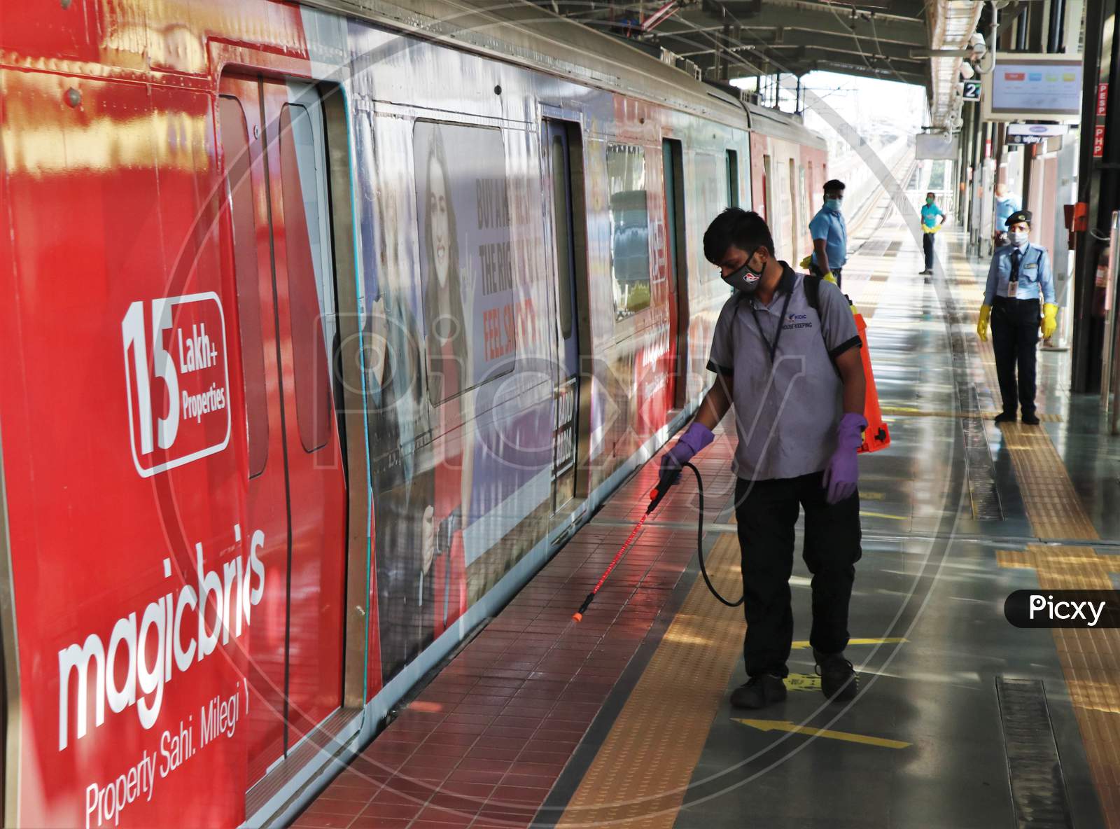 A worker sanitizes a platform as metro network prepares to resume services after more than a 6-month shutdown due to the Covid-19 coronavirus pandemic, at the Andheri metro station in Mumbai, October, 2020.