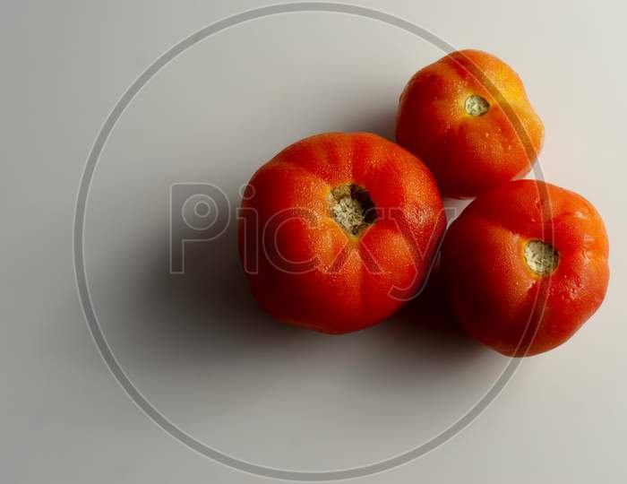 Three Red Tomatoes On The Table