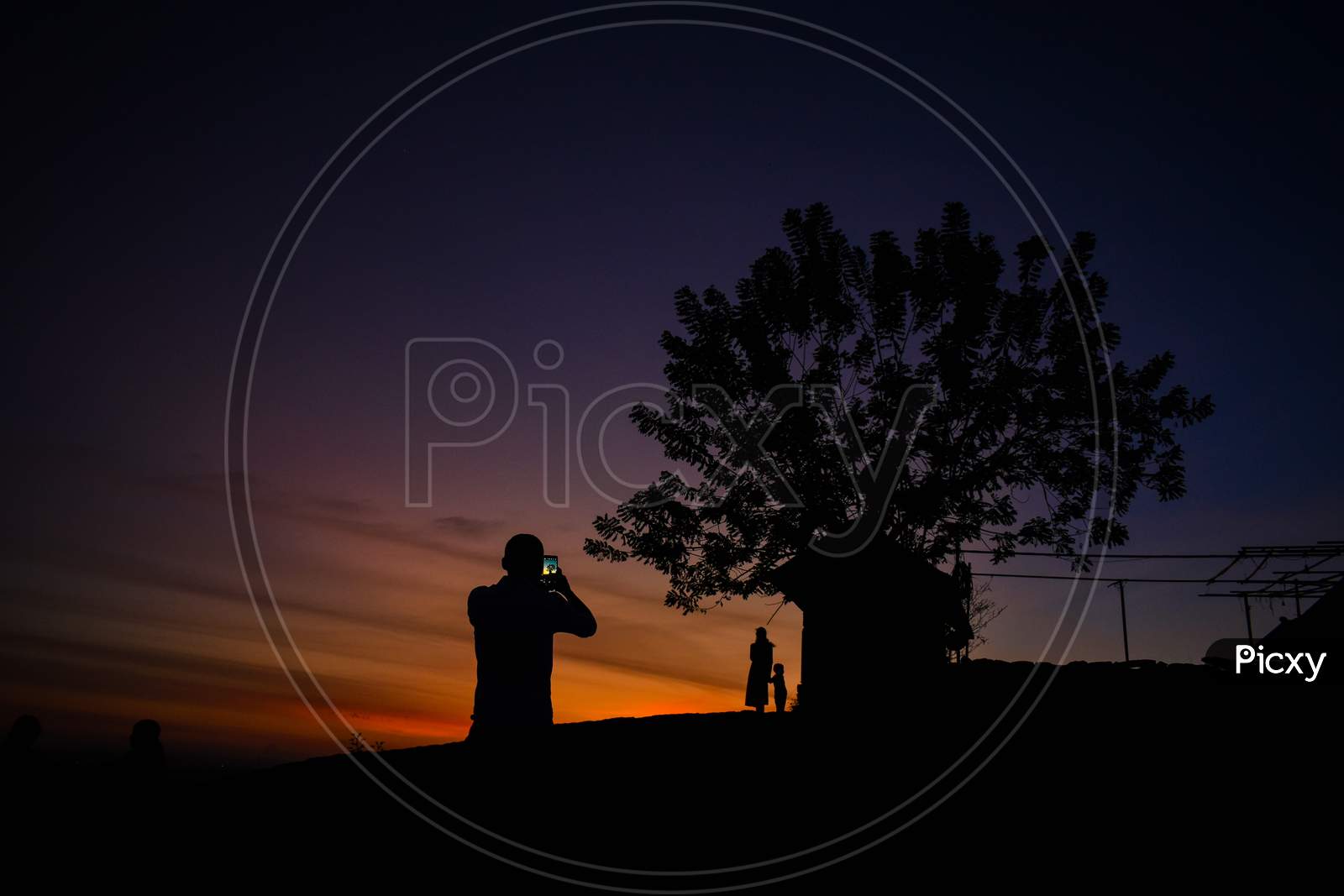 A family enjoying taking photos in sunset