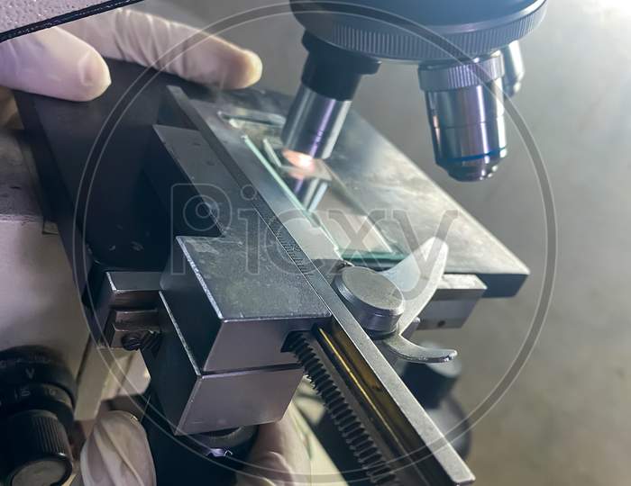 A view of a scientist working on a microscope