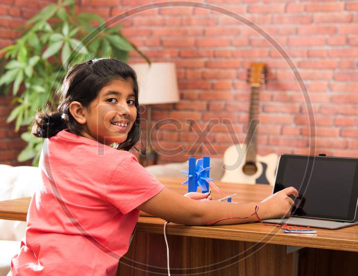 Electronic Experiment - Indian Girl Student Working With Wires And Connections Making Windmill Model