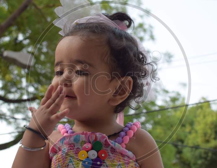 Image Of Sweet Baby Girl In A Wreath, Closeup Portrait Of Cute 12 Months Old Smiling Girl, Toddler, Adorable Little Baby Girl, Smiling And Making Cute Pose For Outdoor Photo Shoot