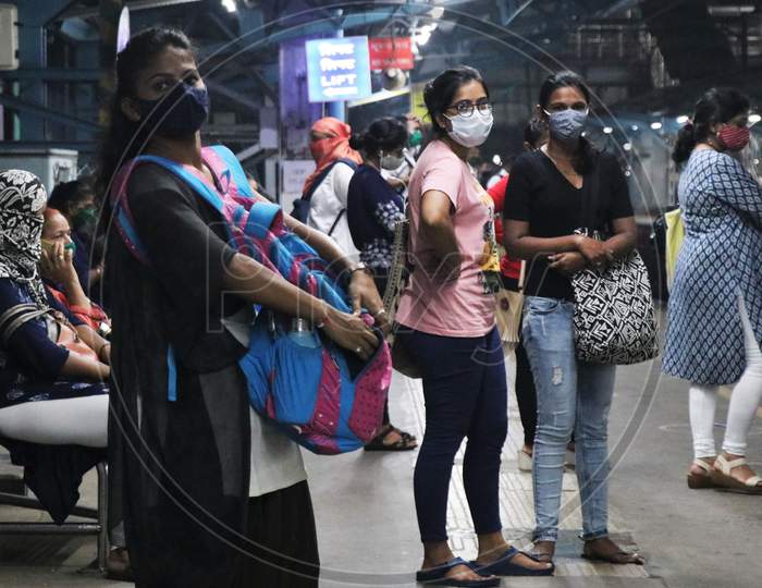 Women wearing protective face masks wait for a local train after authorities resumed the train services for women passengers during non-peak hours, amidst the coronavirus disease (COVID-19) outbreak, in Mumbai, India, October, 2020.