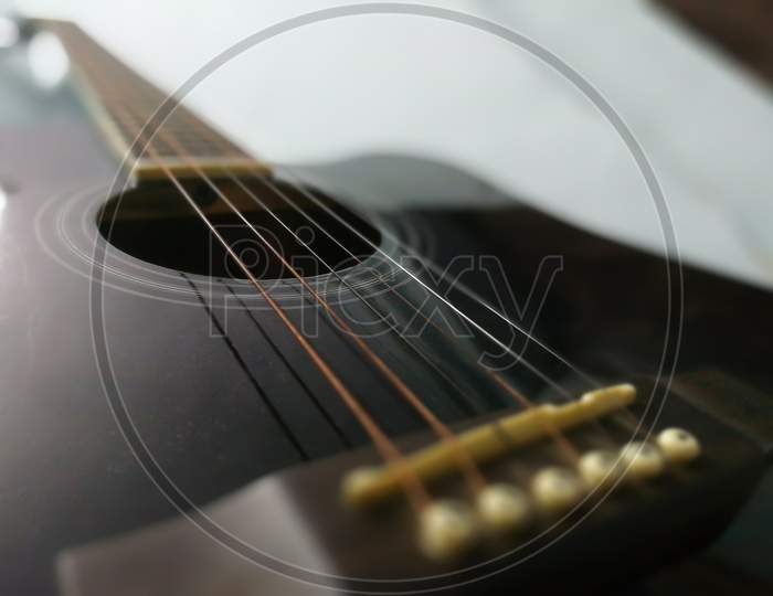 Close-Up Guitar Body With Sound Hole And Strings.Blur Photo