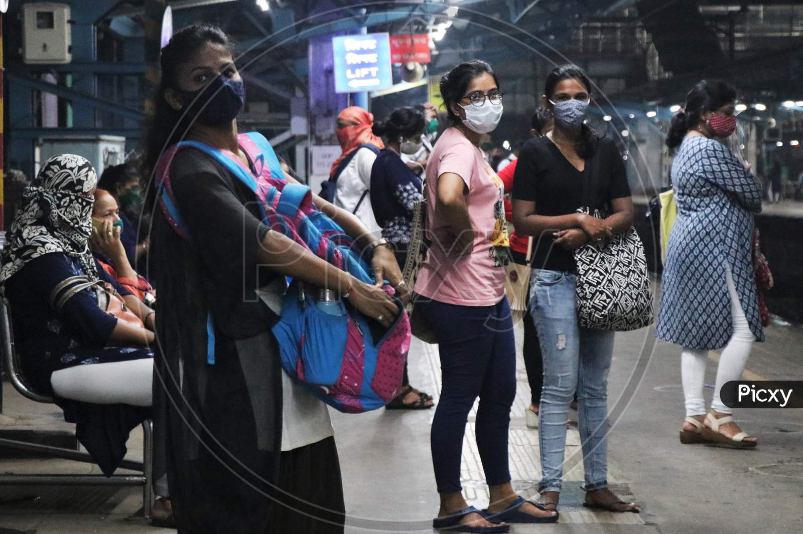 Women wearing protective face masks wait for a local train after authorities resumed the train services for women passengers during non-peak hours, amidst the coronavirus disease (COVID-19) outbreak, in Mumbai, India, October, 2020.