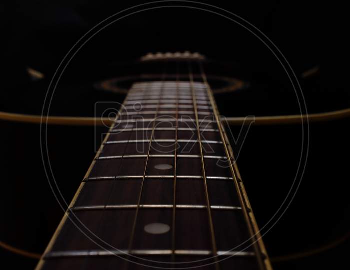 Acoustic Guitar on a dark background