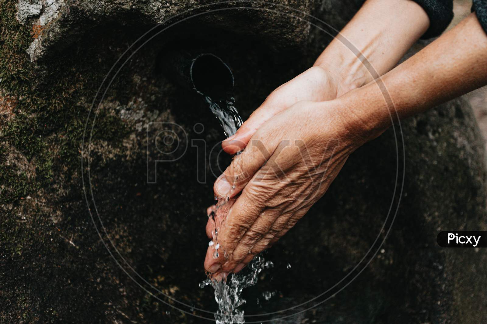 Old Woman Washing Her Hands Close Up Of The Hands In A Source Font With Natural Water