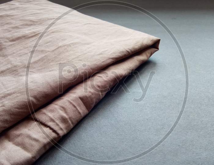 Brown bed sheet cloth on black background