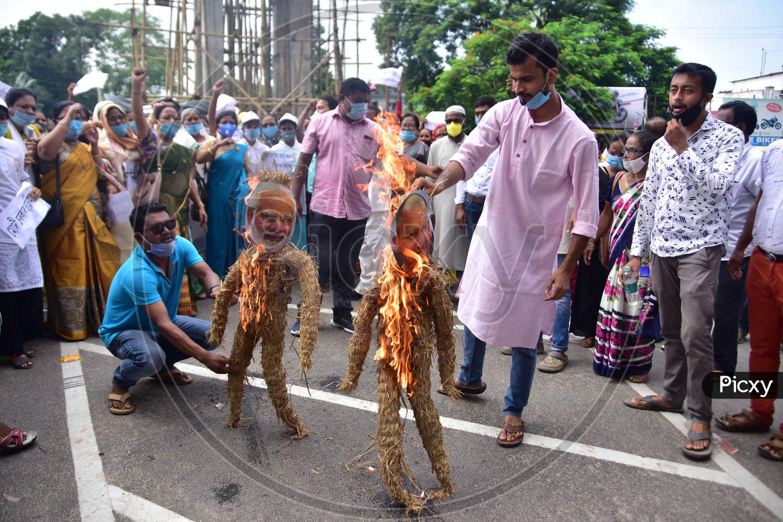 Congress workers  burn an effigy of  Prime minister Narendra Modi and UP CM Yogi Adityanath during a protest against the detention of party leader Rahul Gandhi on his way to Hathras thursday in Nagaon District of Assam on  Oct 3,2020.
