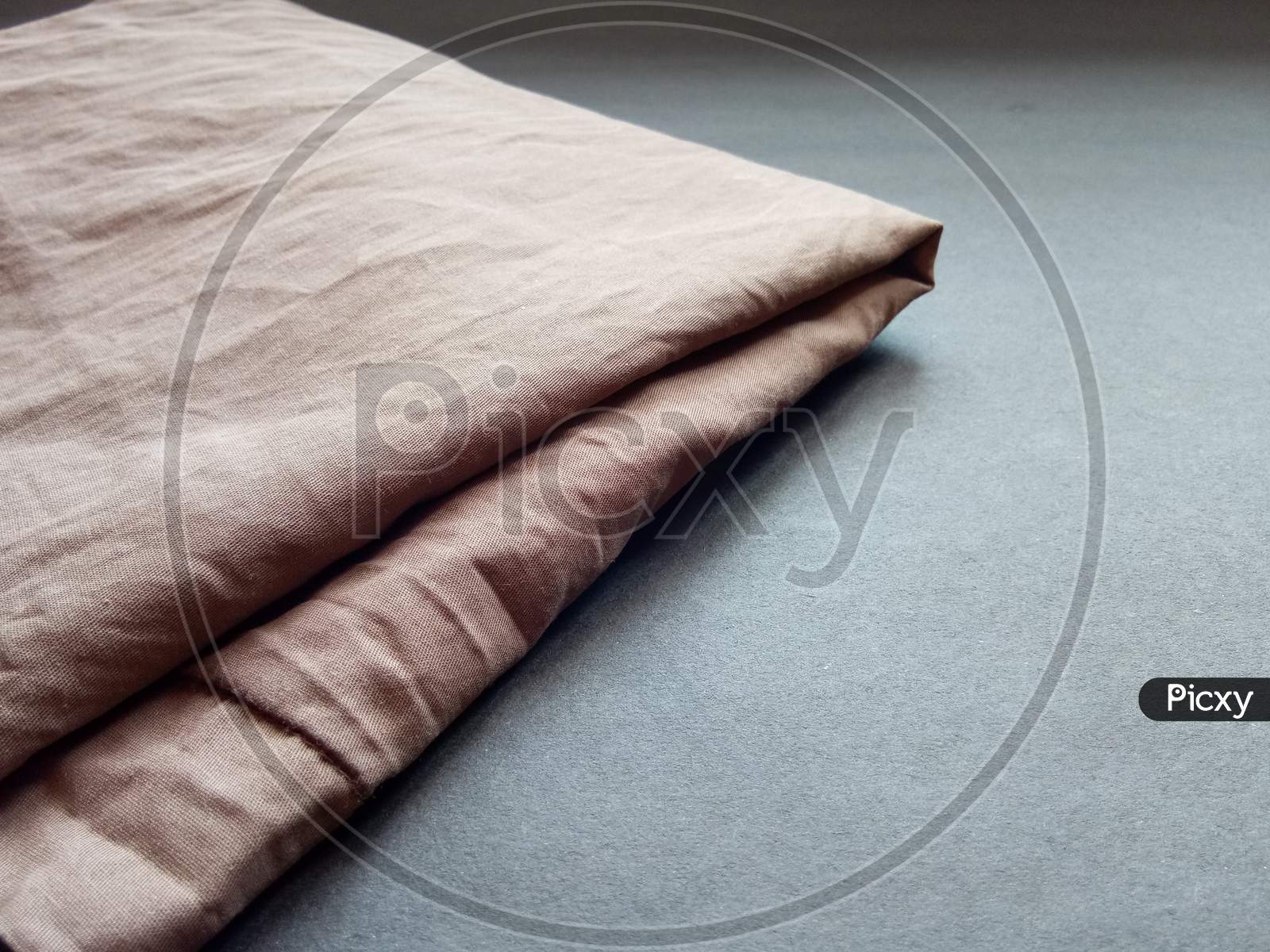 Brown bed sheet cloth on black background