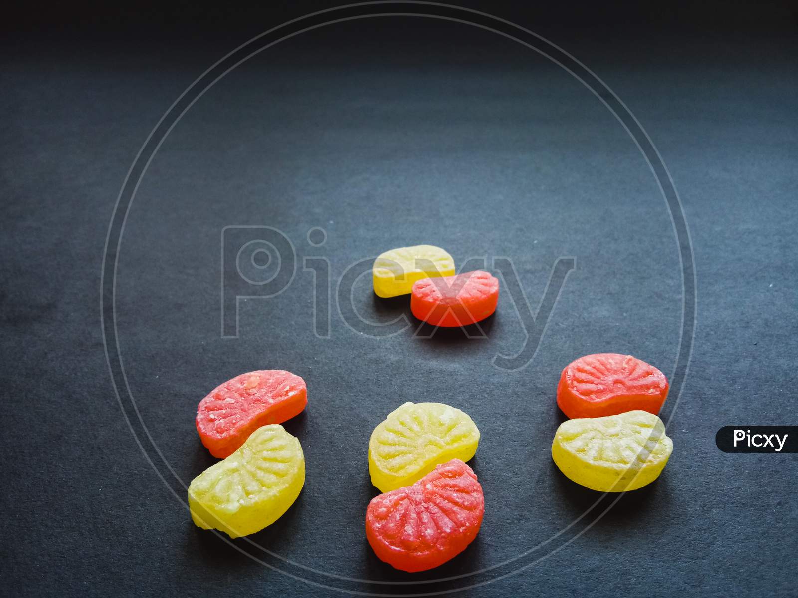 Colorful orange candies in black background