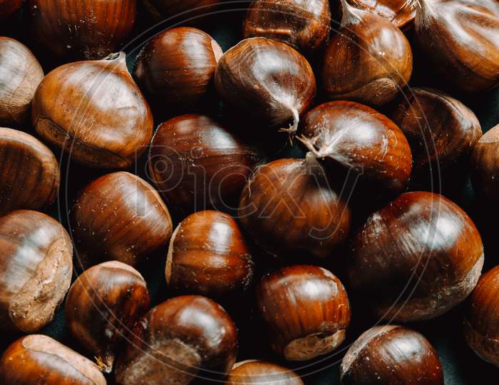 Super Close Up Of A Lot Of Chestnuts With Super Texture And Sharpness With Copy Space