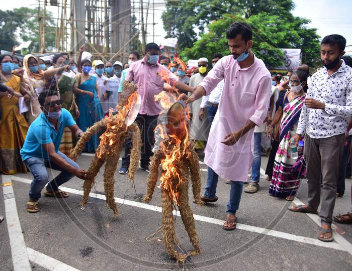 Congress workers  burn an effigy of  Prime minister Narendra Modi and UP CM Yogi Adityanath during a protest against the detention of party leader Rahul Gandhi on his way to Hathras thursday in Nagaon District of Assam on  Oct 3,2020.