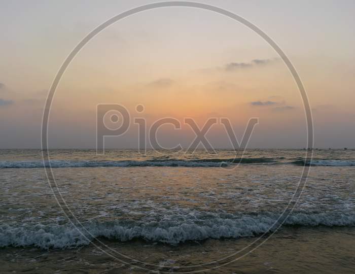 Beautiful View Of Sea Waves Flowing Into Sand At Baga Beach In Goa, India