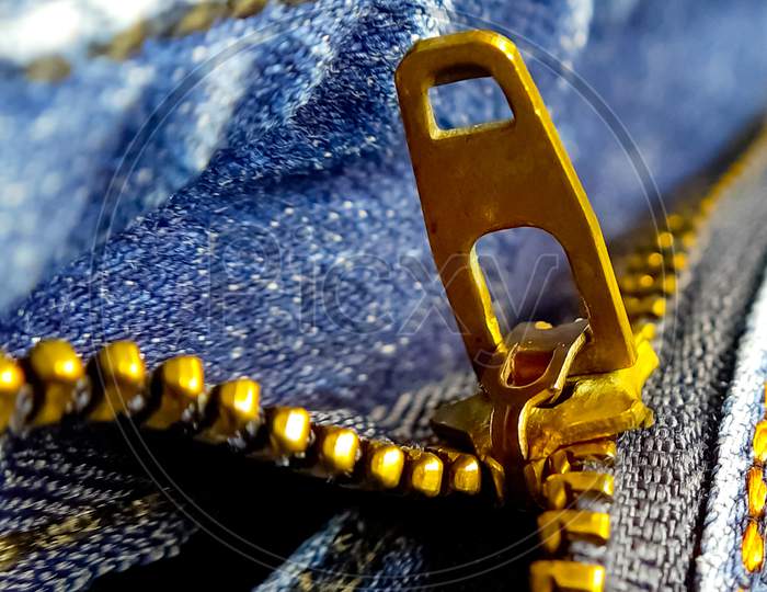 Closeup vertical picture of denim zipper. Macro photography.
