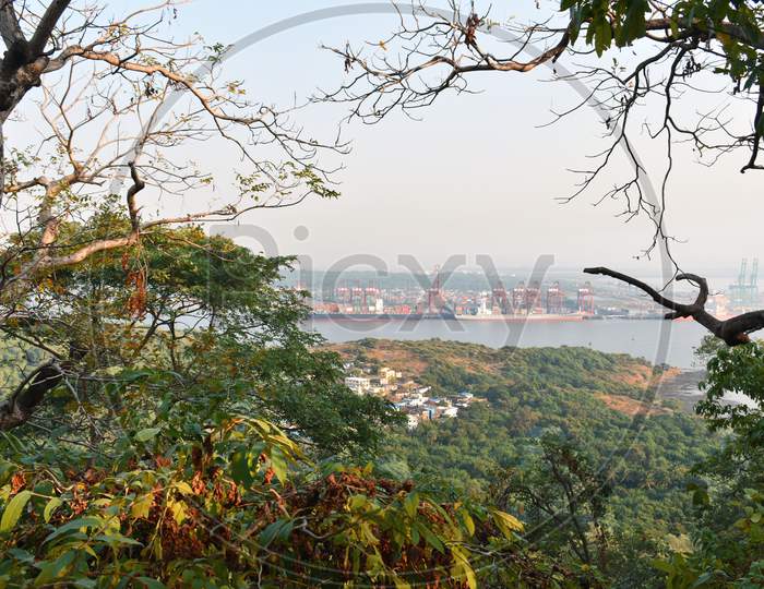Beautiful Mumbai Port Captured From The Top With Colourful Trees In The Foreground.