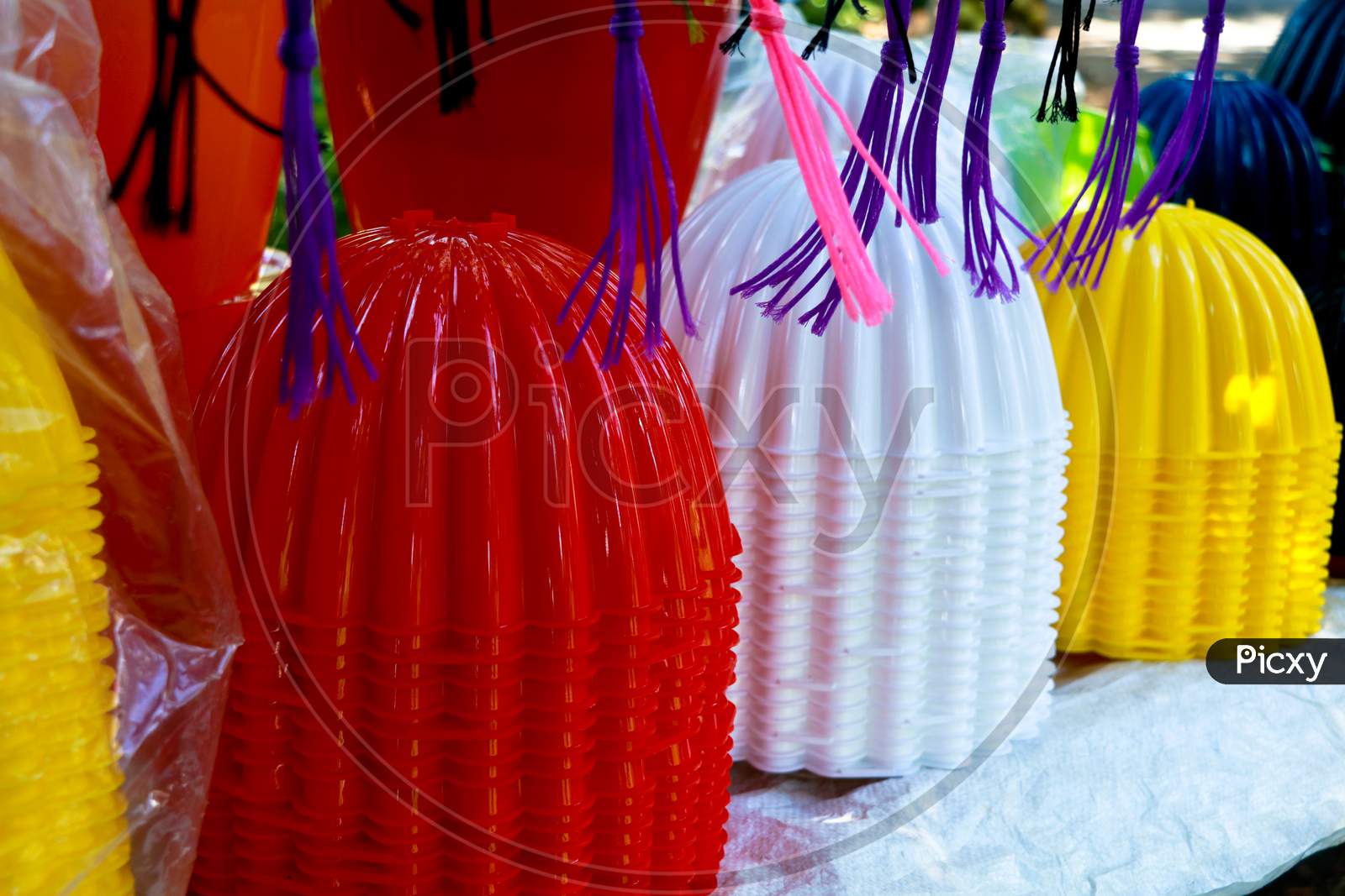 Plastic Flower Vases In Different Colors For Sale On The Roadside