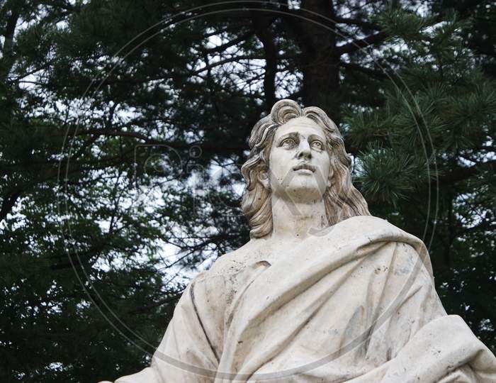White Marble Statue Of Man In A Public Park