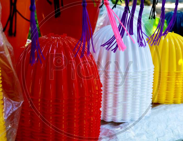 Plastic Flower Vases In Different Colors For Sale On The Roadside