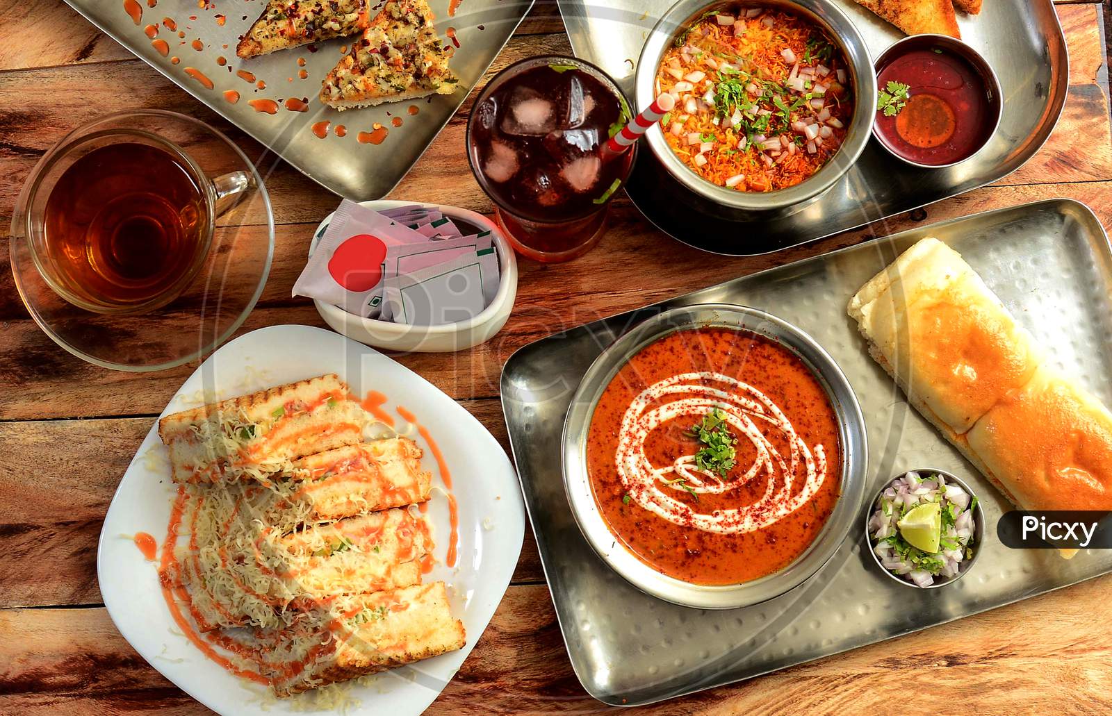 Assorted Snack Items Grilled Cheese Sandwich,Pav Bhaji,Darjeeling Black Tea And Sev Puri Dishes And Appetizers Of Indian Cuisine