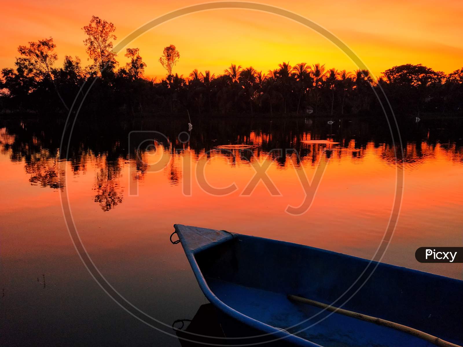 sunset, reflection of colorful sky on water, small boat, twilight
