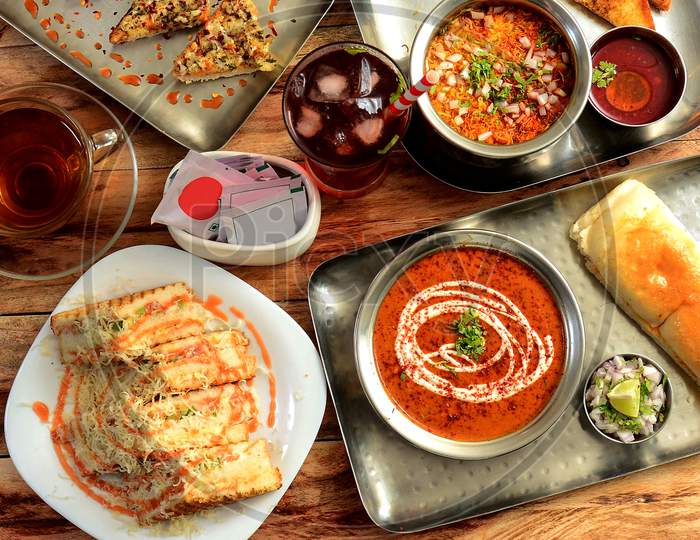Assorted Snack Items Grilled Cheese Sandwich,Pav Bhaji,Darjeeling Black Tea And Sev Puri Dishes And Appetizers Of Indian Cuisine