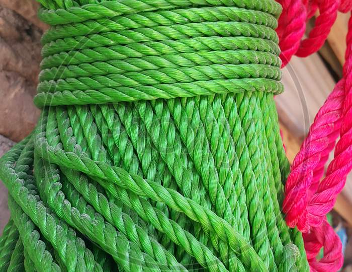 Closeup of bright color braided plastic ropes. Hanks or coil of