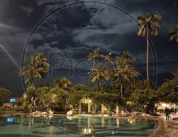 Vibrant night by the swimming pool in a resort