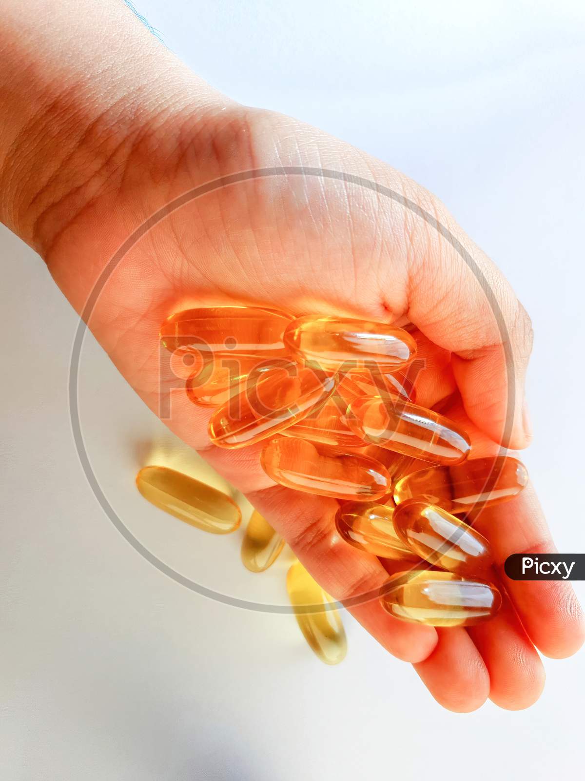 Fish Oil Capsules With Omega 3 And Vitamin D For Daily Supplement, Healthy Diet, Holding On Hand