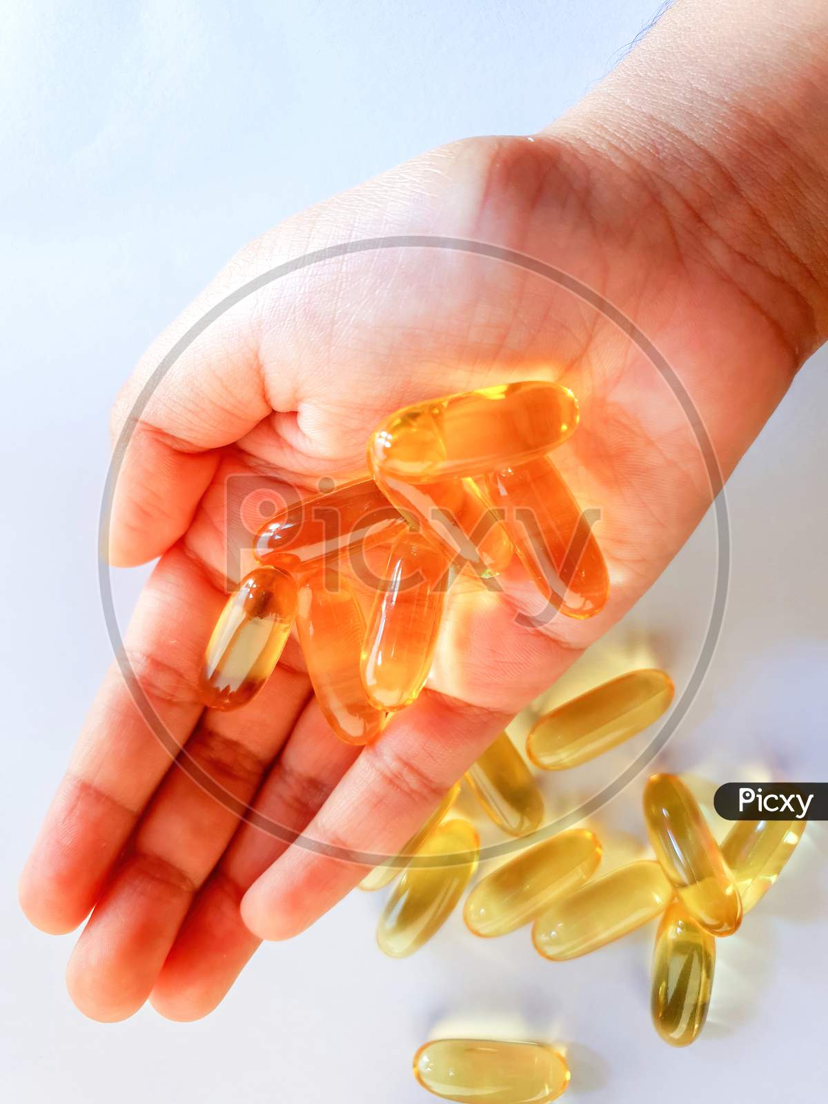 Fish Oil Capsules With Omega 3 And Vitamin D For Daily Supplement, Healthy Diet, Holding On Hand