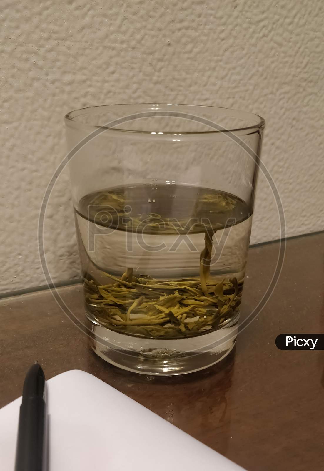 Green tea in a transparent glass on a table