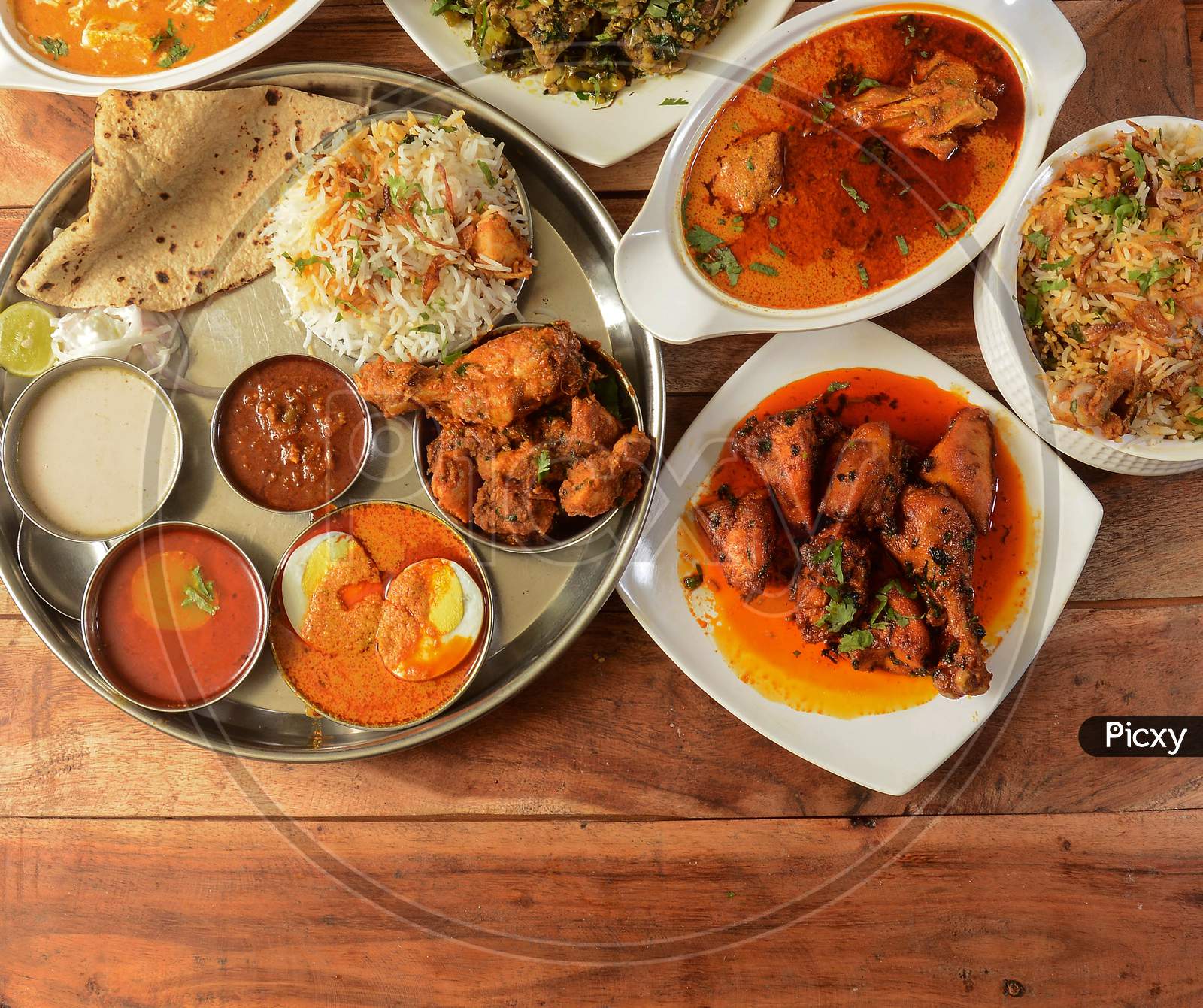 Assorted Indian Foods Pepper Chicken Gravy,Chicken Masala And Nonveg Thali On Wooden Background. Dishes And Appetizers Of Indian Cuisine