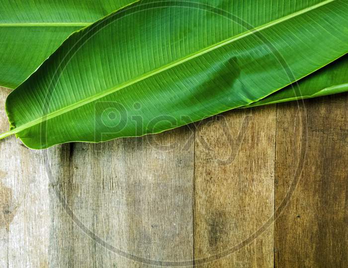 Banana Leaves On Wooden Background Top View