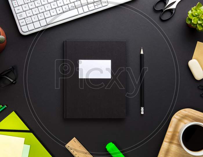 Folder With Label Surrounded By Office Equipment On Gray Desk