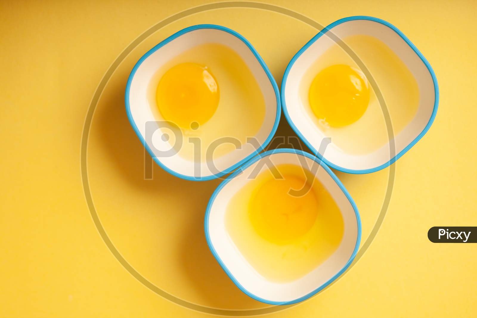 Egg Yellow Yolk In Three Bowls