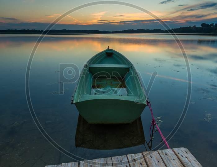 Beautiful Lake Sunset With Fisherman Boats