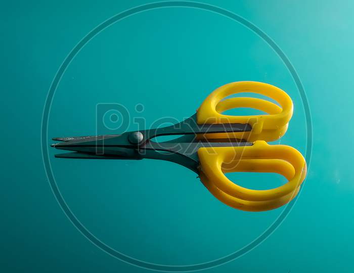 Mini Scissors on blue background